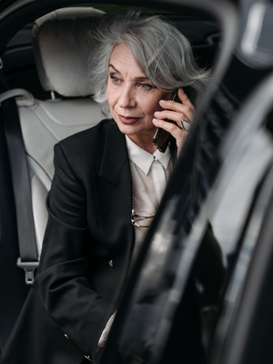 concerned middle- aged woman on phone talking to gps watch for seniors